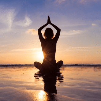 A women doing Yoga exercise at the sunset